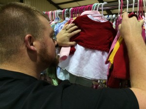 Bo Washington of Clarkesville shops for outfits for his young daughters at the Children's Sale.