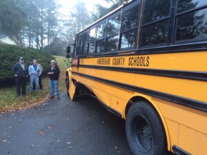 Habersham County school bus driver James Frankum (center) surveys the damage with school transportation director Tim Dockery (left) following the accident.