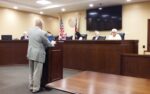 Commissioners Purchase Land and Approve Contracts for Top Administrators
