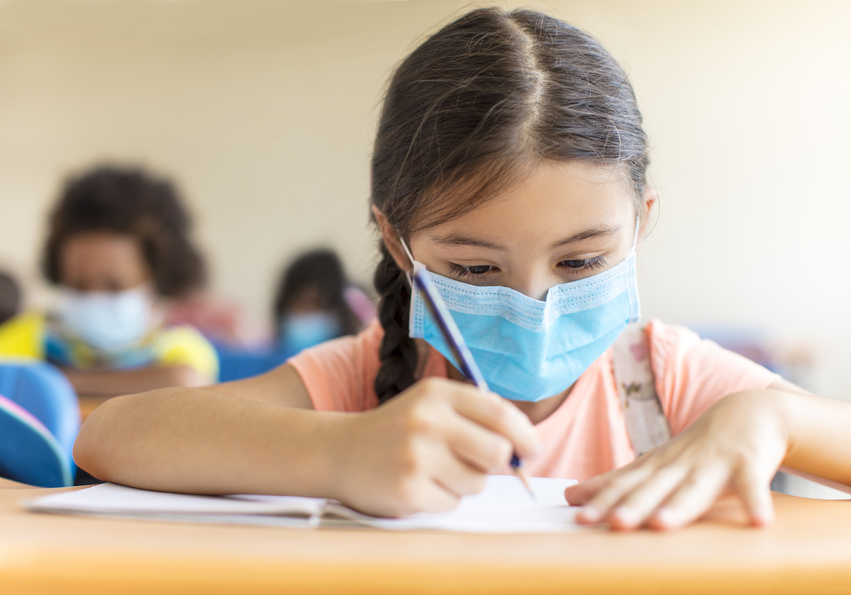 students wearing mask and studying in the classroom.