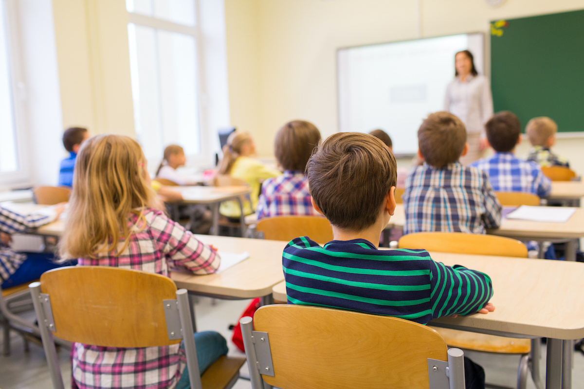 elementary students and teacher in classroom