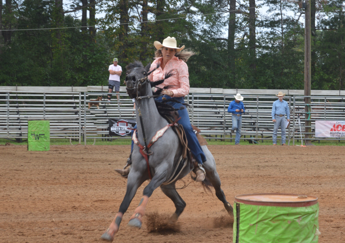 Barrel racer prepares to make the turn around the barrel