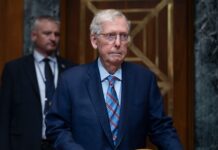 McConnell says a fall led to his hospitalization, breaking weeks of silence