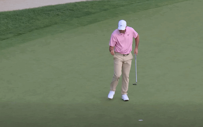 Scottie Scheffler celebrates after sinking a putt to force playoff