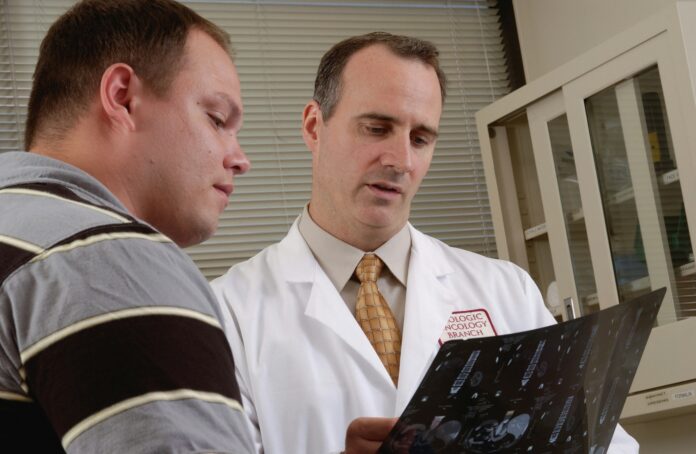 Doctor examines man