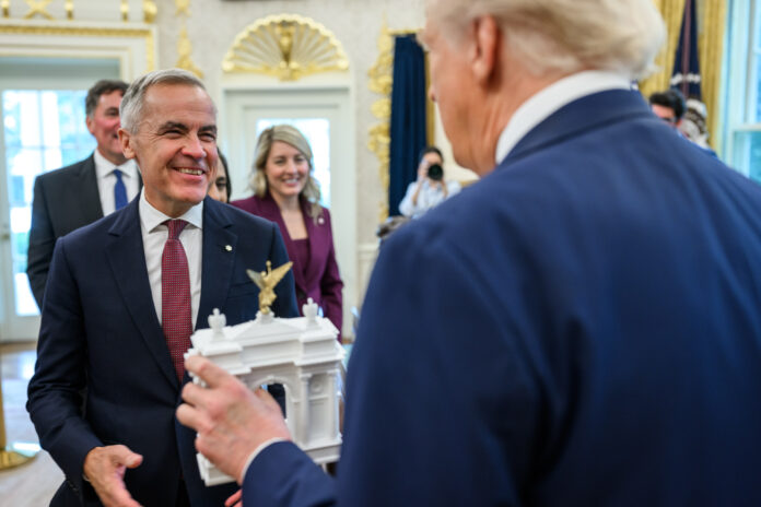 President_Donald_Trump_shows_Canadian_Prime_Minister_Mark_Carney_a_model_of_the_proposed_“Independence_Arch”_before_their_meeting_in_the_Oval_Office_(54870175848)