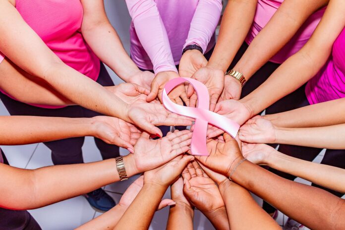 hands with pink ribbon