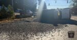 Dump truck overturns after van turns into its path